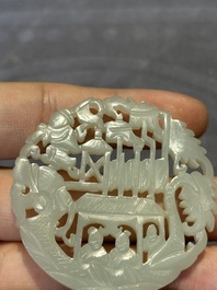 Two Chinese round jade plaques on carved wooden stands, 19th C.
