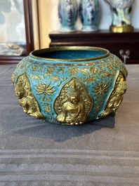 A Chinese gilt and champlev&eacute; enamelled bronze bowl with Buddhas in relief, 19/20th C.