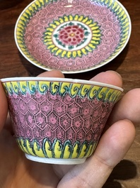 A pair of Chinese famille verte and a pair of famille rose cups and saucers, Kangxi/Yongzheng