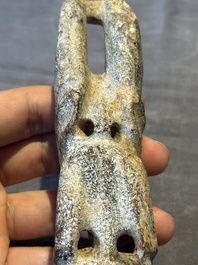 A Chinese jade carving of a crouched figure, possibly Hongshan culture
