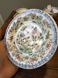 A pair of Chinese famille verte and a pair of famille rose cups and saucers, Kangxi/Yongzheng