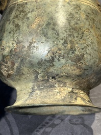 A Chinese archaic bronze ritual wine vessel with buffalo heads, 'zhi 觯', Western Zhou