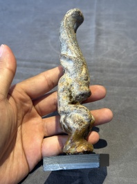 A Chinese jade carving of a crouched figure, possibly Hongshan culture