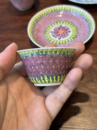A pair of Chinese famille verte and a pair of famille rose cups and saucers, Kangxi/Yongzheng