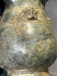 A Chinese archaic bronze ritual wine vessel with buffalo heads, 'zhi 觯', Western Zhou