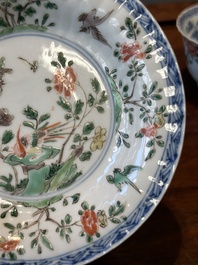 A pair of Chinese famille verte and a pair of famille rose cups and saucers, Kangxi/Yongzheng