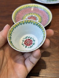 A pair of Chinese famille verte and a pair of famille rose cups and saucers, Kangxi/Yongzheng