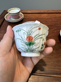 A pair of Chinese famille verte and a pair of famille rose cups and saucers, Kangxi/Yongzheng