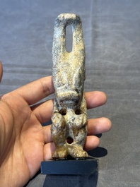 A Chinese jade carving of a crouched figure, possibly Hongshan culture