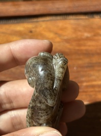 A Chinese partly black coloured white jade dog carving, Qing