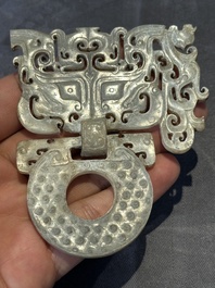 A Chinese nephrite jade 'bi' disc representing a Taotie mask, Han