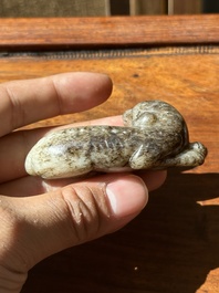 A Chinese partly black coloured white jade dog carving, Qing