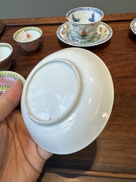 A pair of Chinese famille verte and a pair of famille rose cups and saucers, Kangxi/Yongzheng