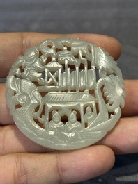 Two Chinese round jade plaques on carved wooden stands, 19th C.