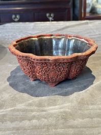 A Chinese red cinnabar lacquer jardiniere with floral design, Yongzheng/Qianlong