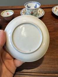 A pair of Chinese famille verte and a pair of famille rose cups and saucers, Kangxi/Yongzheng