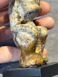 A Chinese jade carving of a crouched figure, possibly Hongshan culture