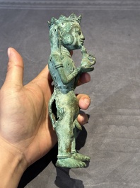 An fine Indonesian bronze sculpture of a naked man offering a sacrificial vase, Majapahit, East Java, 13/14th C.