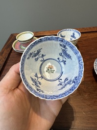 A pair of Chinese famille verte and a pair of famille rose cups and saucers, Kangxi/Yongzheng