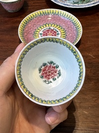 A pair of Chinese famille verte and a pair of famille rose cups and saucers, Kangxi/Yongzheng