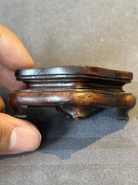 A Chinese bronze paperweight in the form of 'Shi De 拾得' on wooden stand, 16th C.