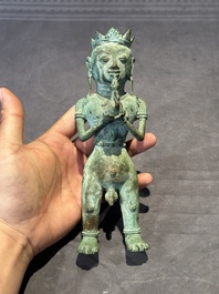An fine Indonesian bronze sculpture of a naked man offering a sacrificial vase, Majapahit, East Java, 13/14th C.