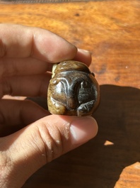 A Chinese celadon and russet jade mythical beast carving, Ming