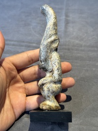 A Chinese jade carving of a crouched figure, possibly Hongshan culture