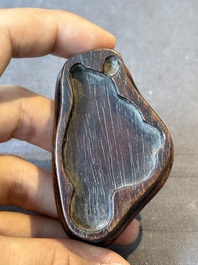 A Chinese bronze paperweight in the form of 'Shi De 拾得' on wooden stand, 16th C.