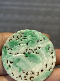 Two Chinese round jade plaques on carved wooden stands, 19th C.