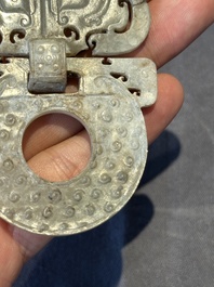 A Chinese nephrite jade 'bi' disc representing a Taotie mask, Han