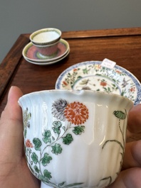 A pair of Chinese famille verte and a pair of famille rose cups and saucers, Kangxi/Yongzheng