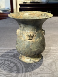 A Chinese archaic bronze ritual wine vessel with buffalo heads, 'zhi 觯', Western Zhou