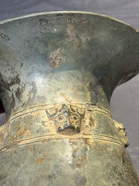 A Chinese archaic bronze ritual wine vessel with buffalo heads, 'zhi 觯', Western Zhou