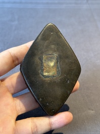 A Chinese reticulated lozenge-shaped double-walled bronze water dropper, 16th C.