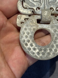 A Chinese nephrite jade 'bi' disc representing a Taotie mask, Han