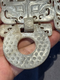 A Chinese nephrite jade 'bi' disc representing a Taotie mask, Han