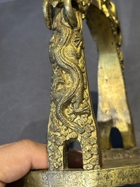 A pair of Chinese imperial gilt-bronze stirrups with dragons, De 德 mark, 18th C.