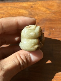 A Chinese celadon and russet jade mythical beast carving, Ming