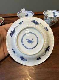 A pair of Chinese famille verte and a pair of famille rose cups and saucers, Kangxi/Yongzheng