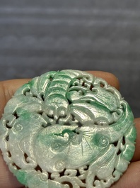 Two Chinese round jade plaques on carved wooden stands, 19th C.