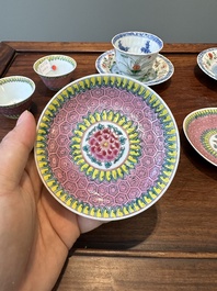 A pair of Chinese famille verte and a pair of famille rose cups and saucers, Kangxi/Yongzheng