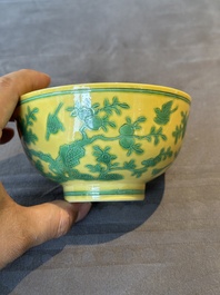 A pair of Chinese yellow-ground 'peach and bird' bowls, Qianlong mark and probably of the period