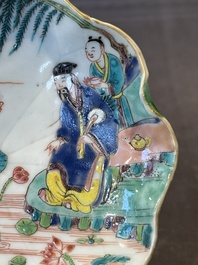 A Chinese famille rose relief-decorated 'lotus' cup and saucer, Yongzheng