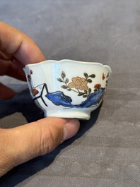 A Chinese polychrome cup and saucer with figures and a dog, Yongzheng