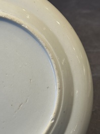A pair of Chinese Canton famille rose plates with figures in a garden, 19th C.