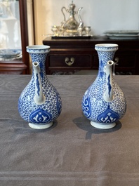 A pair of Chinese blue and white ewers with floral design, Kangxi