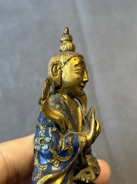A Chinese gilt and champlev&eacute; enamelled bronze Bodhisattva on a carved stone stand, Qing