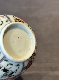 A Chinese famille rose cup and saucer with figures and animals, Yongzheng