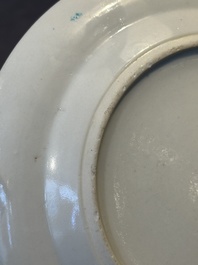 A pair of Chinese Canton famille rose plates with figures in a garden, 19th C.